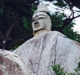 Rock-carved Standing Buddha