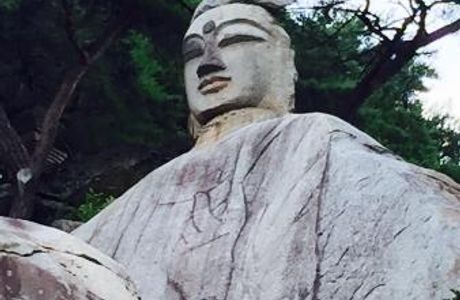 Rock-carved Standing Buddha
